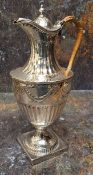 A George III silver urnular hot water pot and cover, half fluted below ribbon tied swags, domed