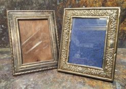 A Victorian style silver rectangular easel photograph frame, embossed with flowerheads and