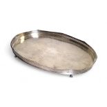 A large E.P. on Copper oval gallery tray, the field die stamped with foliate scrolls, gadrooned rim,