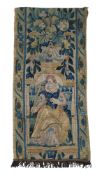 A late 17th century/early 18th century woolwork tapestry fragment, embroidered with lady holding a