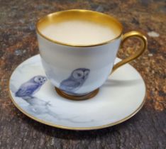 A Royal Worcester demi-tasse cup and saucer,  painted in the  style of Raymond Rushton, with owls,