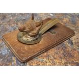 An early 20th century cold painted letter clip, as a fox, wooden base, 14cm wide, c.1910