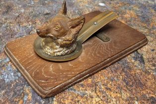 An early 20th century cold painted letter clip, as a fox, wooden base, 14cm wide, c.1910