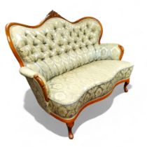 A small French salon sofa, with serpentine shaped button back, cabriole legs, 137cm wide