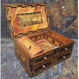 A Napoleonic prisoner of war straw work box, hinged cover decorated with buildings, above one