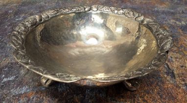 A South American silver coloured metal shaped circular bowl, ring loop handles, ball and claw