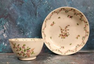 A Chinese tea bowl and saucers, decorated with famille rose flowers, c.1770