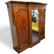 A Victorian mahogany compactum breakfront wardrobe, arched mirror flanked by two conforming