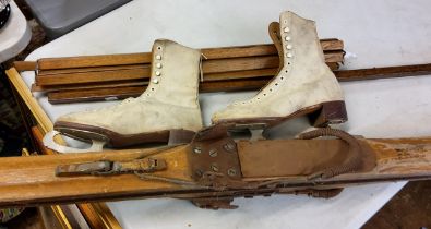 A mid 20th century pair of skis;  ski boots;  stair rods