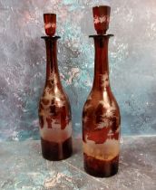 A pair of 19th century Bohemian ruby glass bottle decanters, etched with stags amongst foliage, 35.