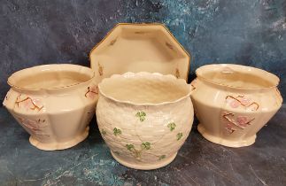 A pair of Belleek lobed jardinieres, decorated in relief with  blossoming branches, 16cm diam, green