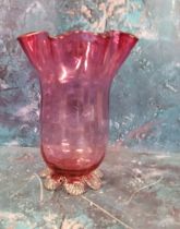 A Victorian cranberry glass vase, flared undulating rim, clear printee feet, 17.5cm high, c.1880