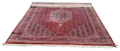 A Royal Keshan wool pole rug with a central double pendant medallion on a sapphire and rouge field