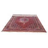 A Royal Keshan wool pole rug with a central double pendant medallion on a sapphire and rouge field