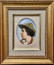 A 19th century German porcelain oval plaque, probably Berlin, portrait of a young boy wearing a hat,