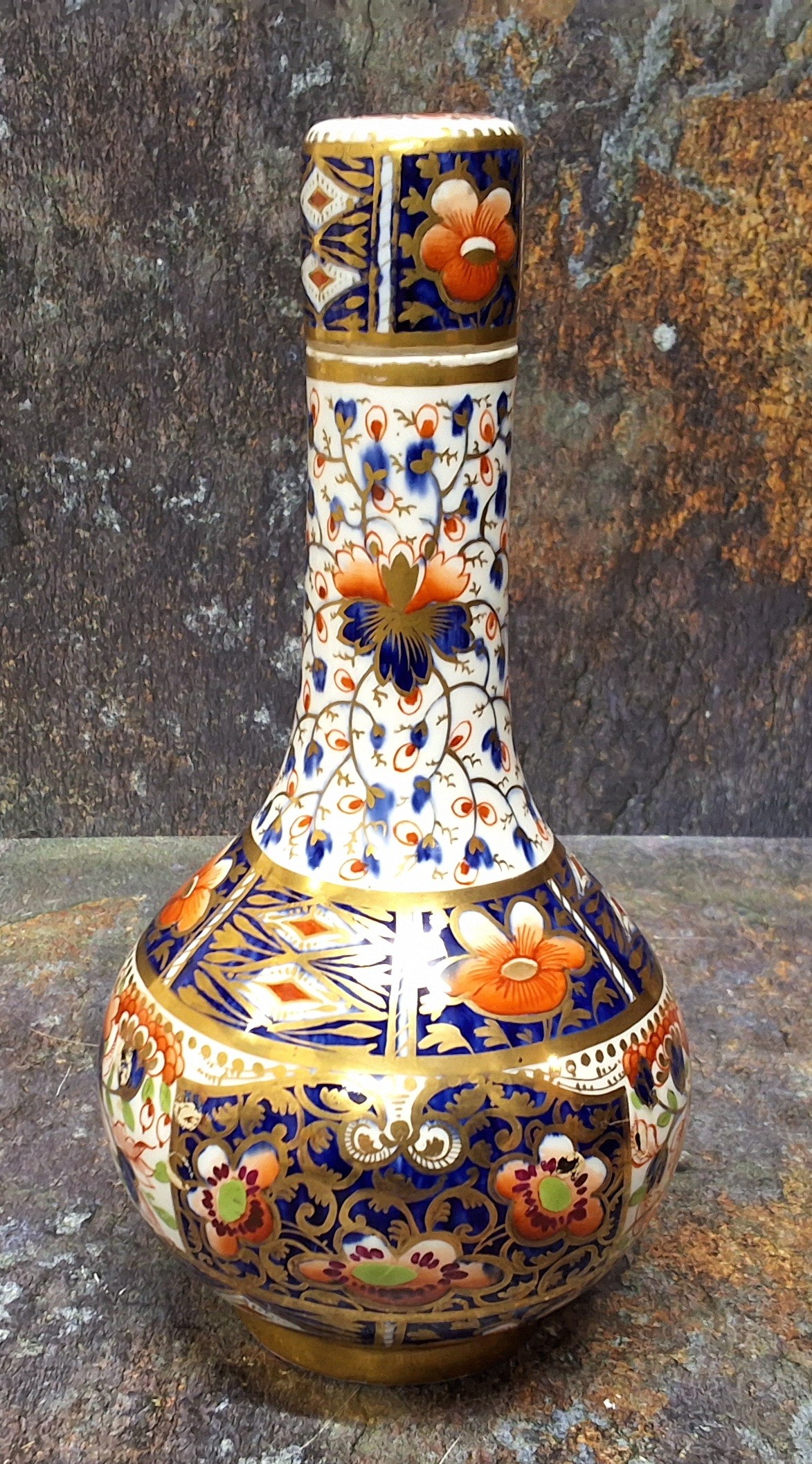 A Derby bottle vase and cover, decorated in the Imari palette, 25cm high, crown, crossed batons