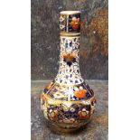 A Derby bottle vase and cover, decorated in the Imari palette, 25cm high, crown, crossed batons