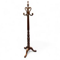 A reproduction mahogany coat stand, in the Victorian manner, turned and fluted column, cabriole