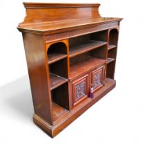 A Victorian walnut bookcase, scroll cresting rail, glazed doors, adjustable shelves, the