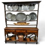 A George III oak plate rack, with moulded cornice, shaped apron, three open shelves, 127cm high,