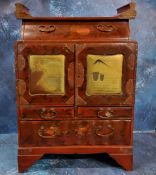 A Chinese red lacquered wooden two-door cabinet, decorated in gilt with flowers and monumental