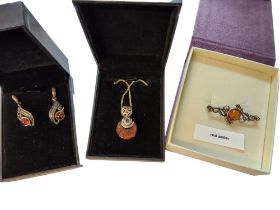 A Goldmajor silver & amber bar brooch set with a round amber cabochon, 3.36g gross; a pair of silver