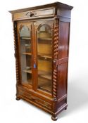 A substantial 19th century display cabinet, arched glazed doors flanked by open barley twist