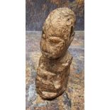 An unusual fossilized wood carving, of a head, 12cm high