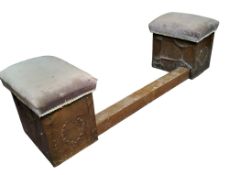 An early 20th century hammered copper fire side fender, with two stuffed-over rectangular chairs,