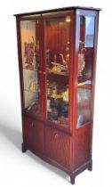 A Stag glazed display cabinet, 180cm high, 90cm wide