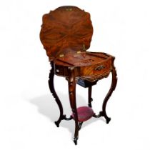 A Victorian quarter veneered flamed mahogany sewing table, shaped oval top inset with Islamic