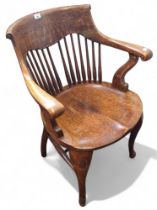 A late 19th/early 20th  century oak office captains chair, spindle back, shaped seat, cabriole legs,