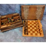 A late 19th century games compendium, turned wooden chess pieces, draughts, etc, the oak box with