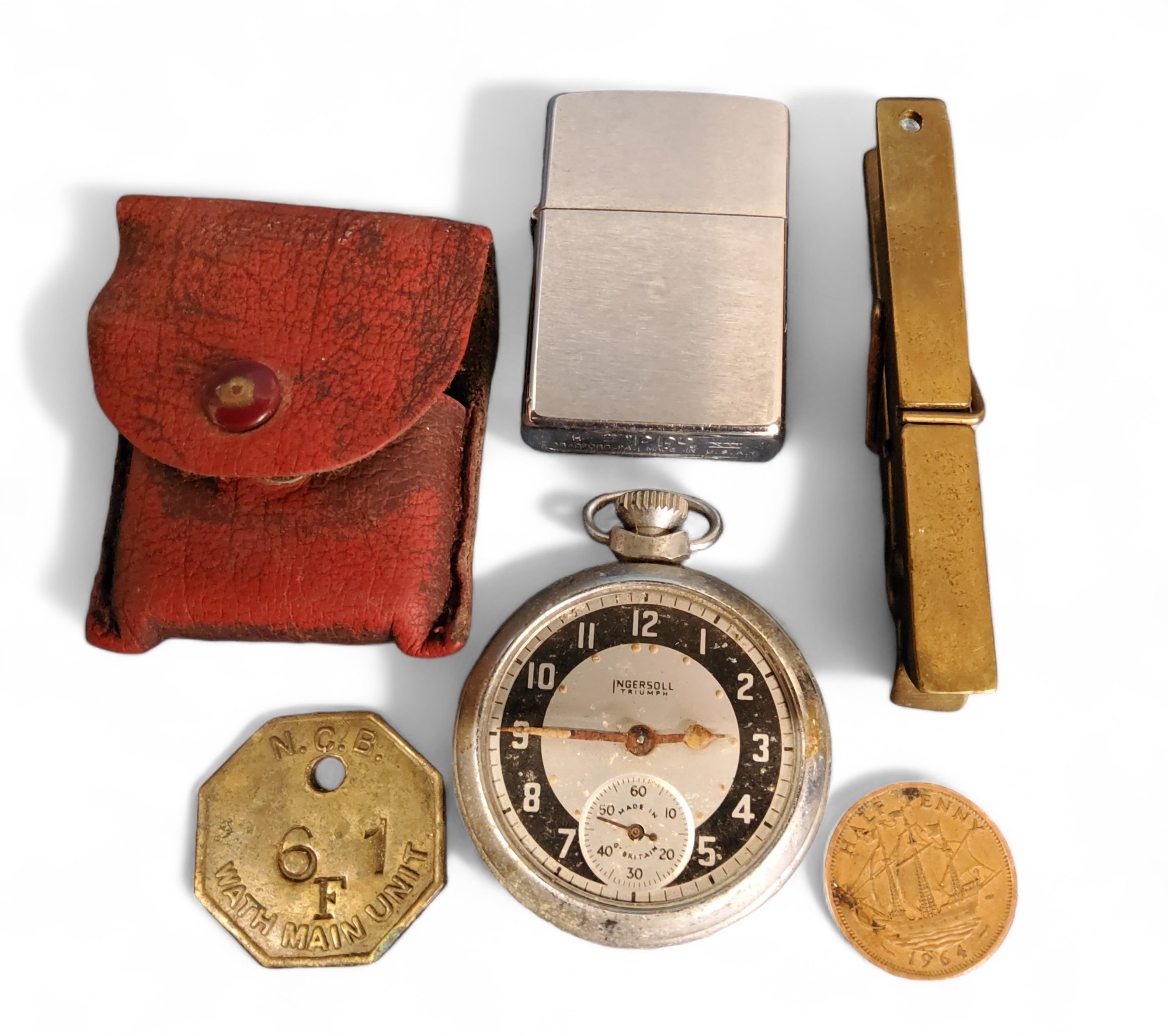 A National Coal Board Pit token, Wath Main Unit 6F1;  a Zippo lighter;  an Ingersoll Triumph