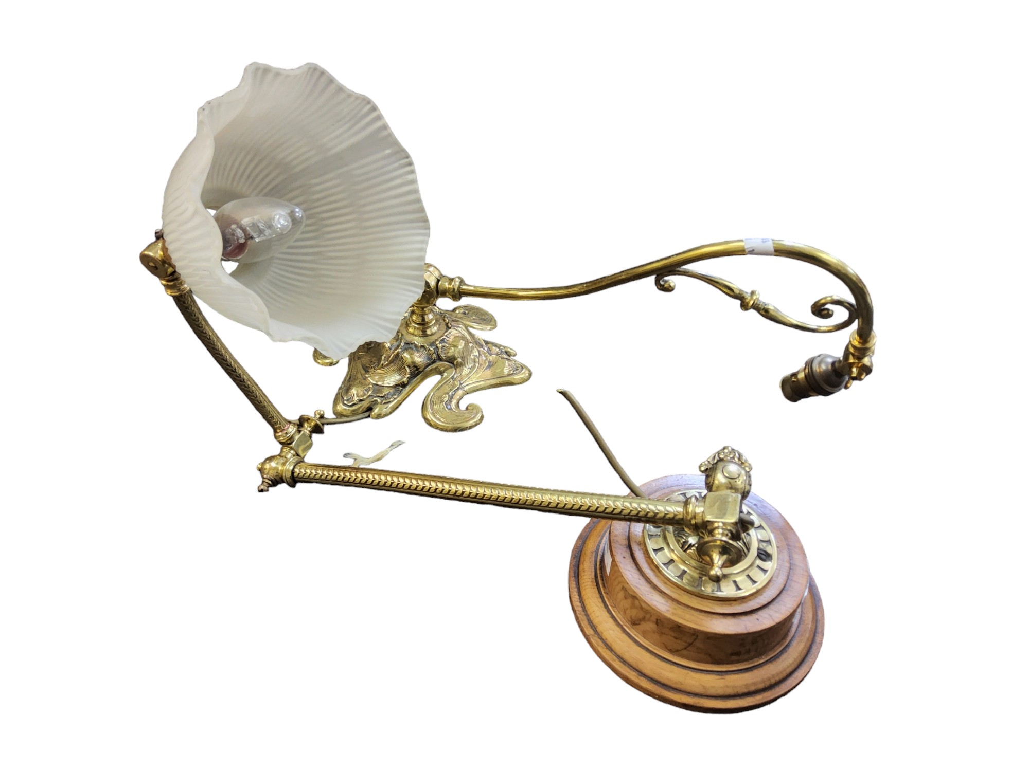 A gilt metal hall table light, with frosted fluted  shade, adjustable scroll arm,  wooden base, 52cm