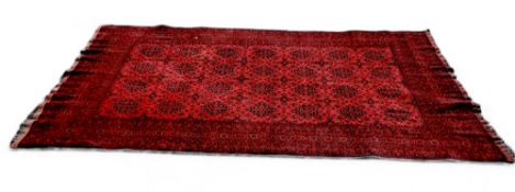 A 19th century Afghan Bukhara rug, vivid tones of maroon and sang de bouf, 320cm x 194cm