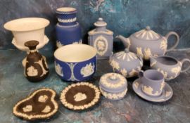 A Wedgwood Blue Jasperware three piece tea service, each sprigged in white, the teapot 15cm high,