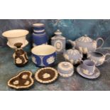 A Wedgwood Blue Jasperware three piece tea service, each sprigged in white, the teapot 15cm high,