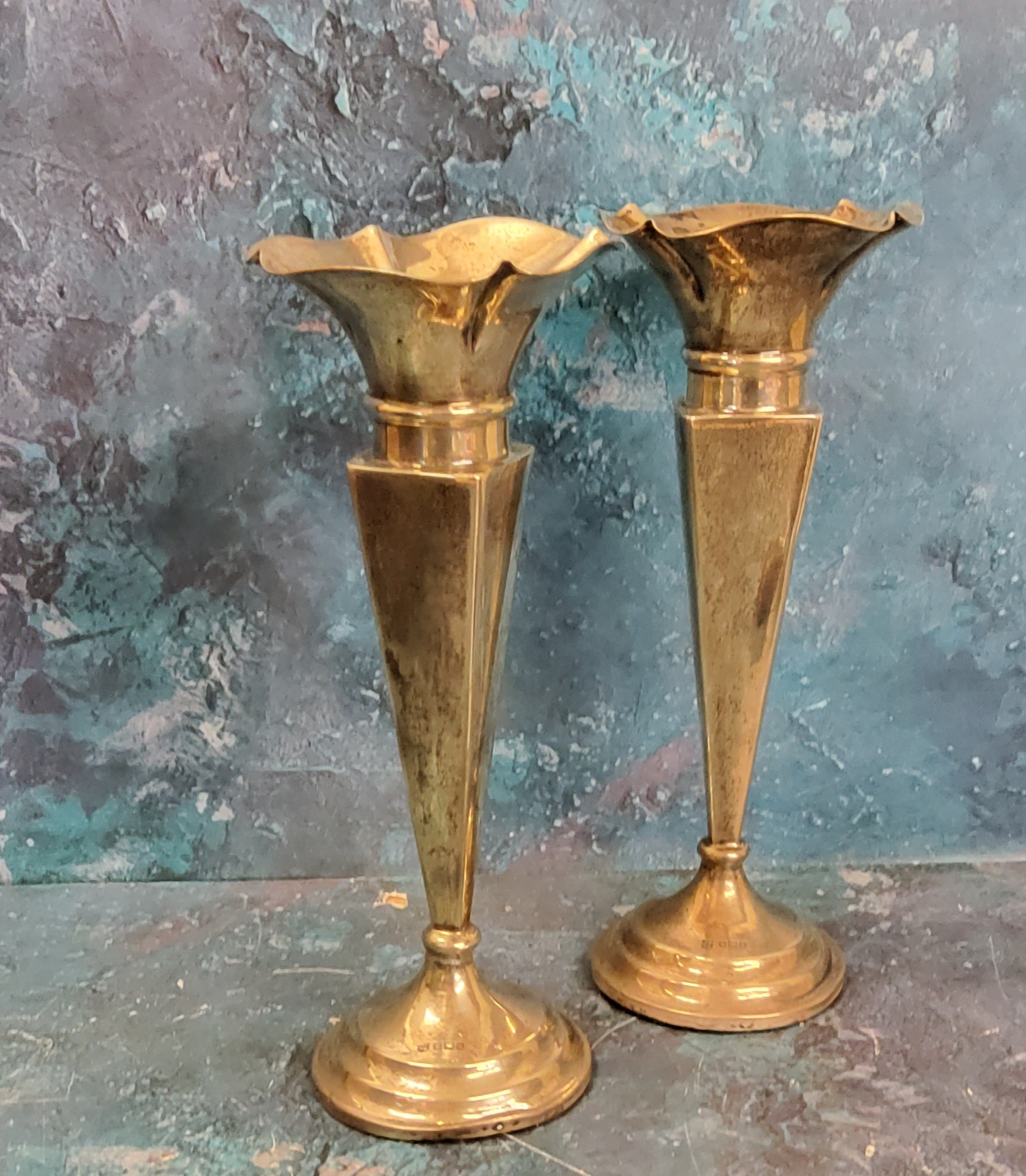 A pair of silver trumpet shaped vases, of panelled form, undulating rims, 24cm high, Sheffield 1905