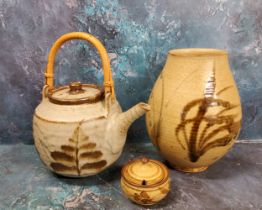 A Studio Pottery teapot, in the Cornish manner, bamboo handle, 30cm high, seal mark;  a similar