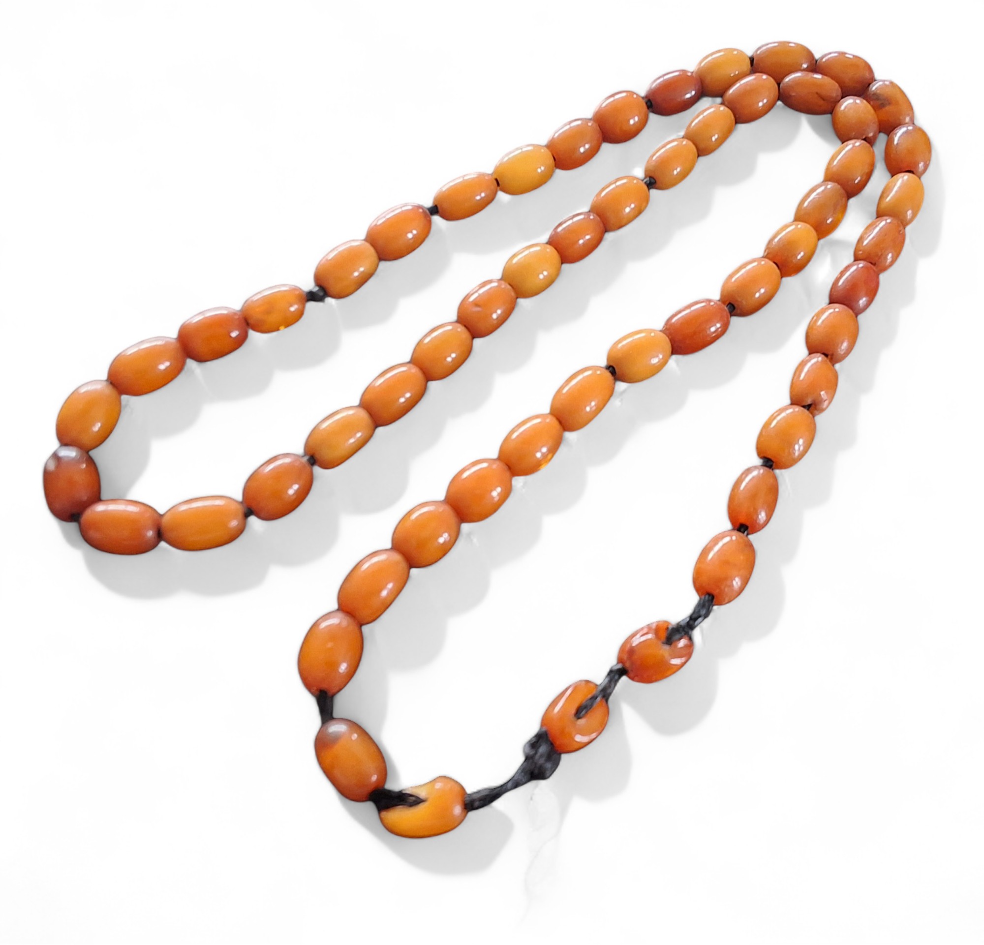 A butterscotch amber oval bead necklace, approx. measuring 10mm x 9mm each 25.84g gross