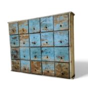 Industrial Salvage - A wall mounted bank of twenty small drawers