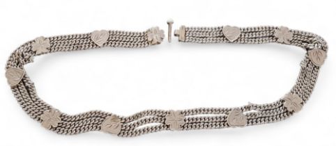 An Indian white three row metal curb link belt, surmounted by alternating hearts & clover leaves,