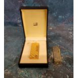 A gold plated Dunhill lighter, engraved with hatches, 6.5cm high, 15635, boxed;   another, Paola