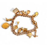 A 9ct gold charm bracelet, eleven charms including a kidney bean, pig, riding boot, £1 In  Emergency
