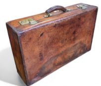 An early 20th century leather suitcase, brass locks, 38cm high, 90cm wide, c.1920