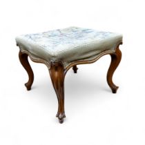 A Victorian walnut shaped rectangular foot stool, tapestry top, cabriole legs, 45cm high, 52cm wide,