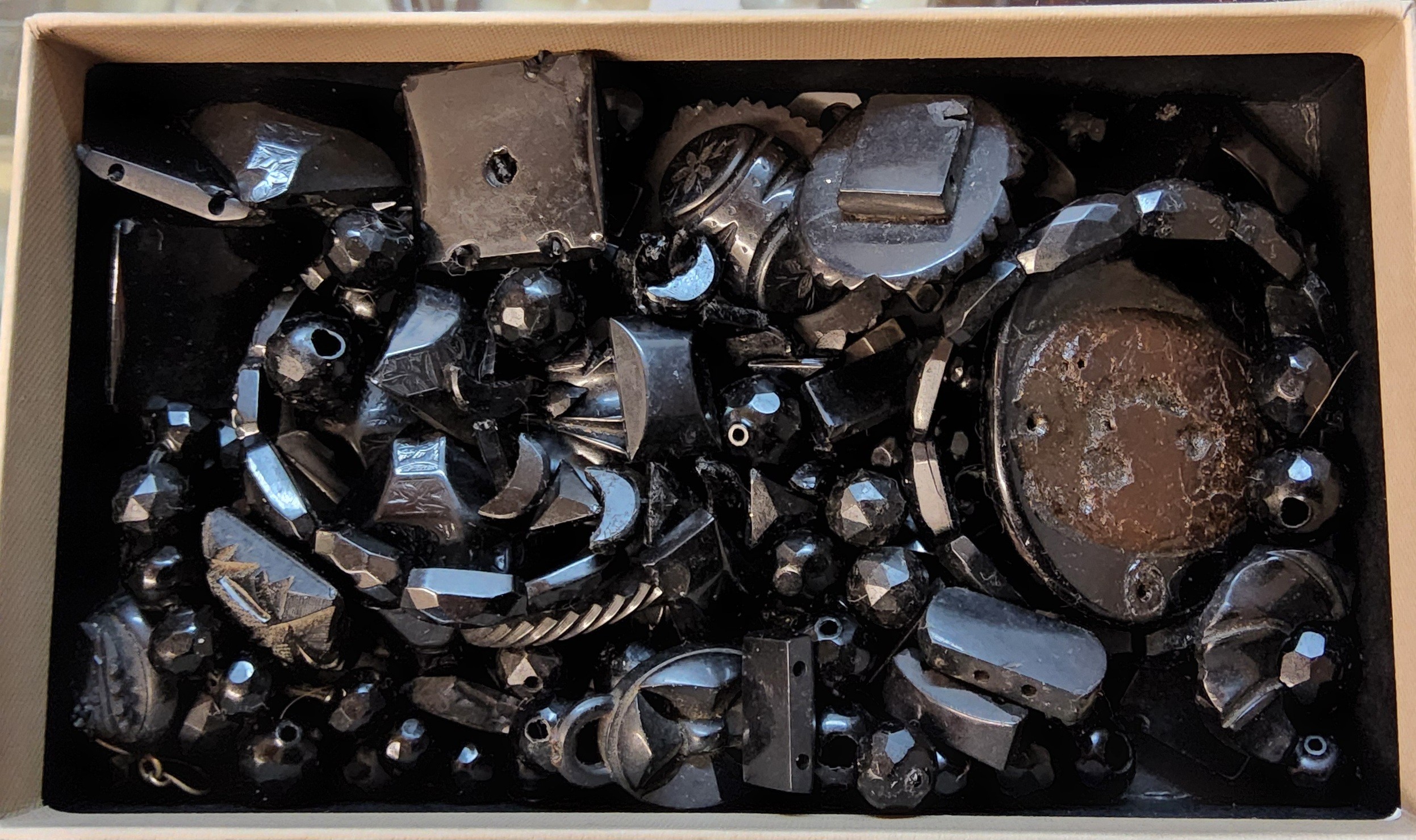 Various Whitby Jet fragments including bracelet links, beads, some carved, etc.