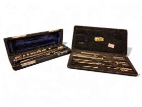 A piccolo, cased;   a Riefler drawing instrument set, cased (2)