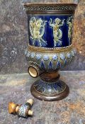 A Doulton Lambeth stoneware water filter, in relief with dancing cherubs, the base with stiff